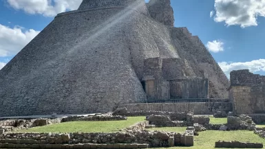 gray pyramid under blue sky during daytime Uxmal ruins