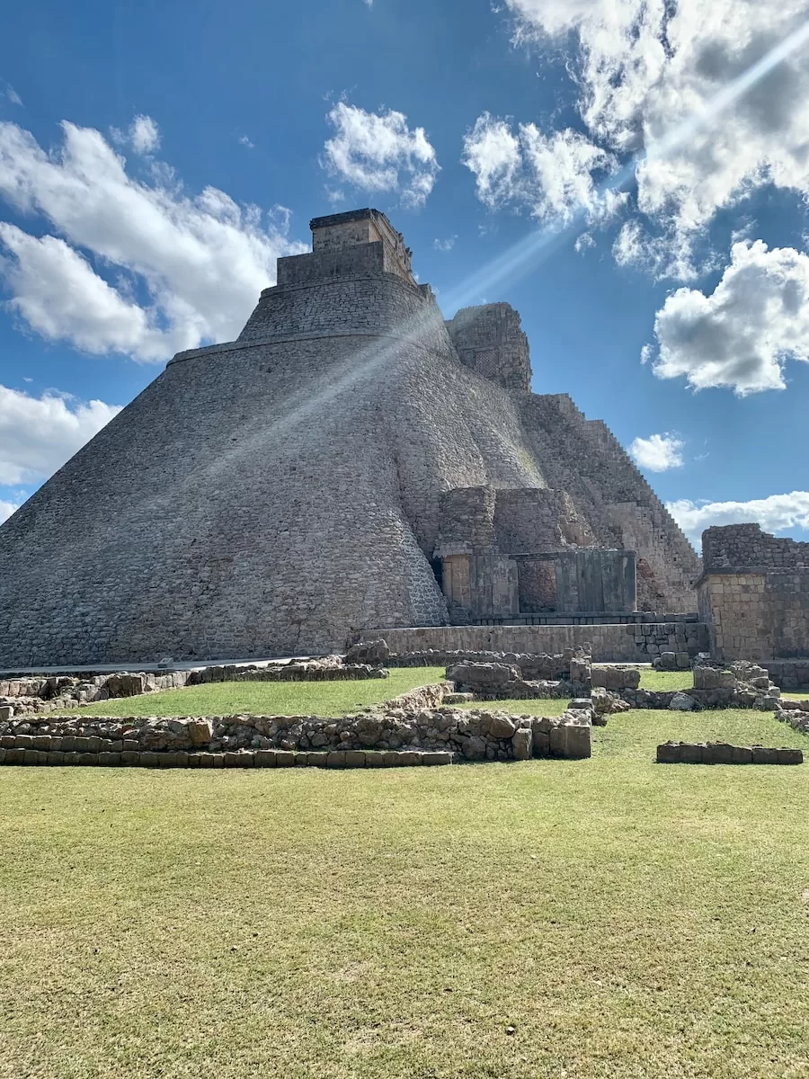 gray pyramid under blue sky during daytime Uxmal ruins