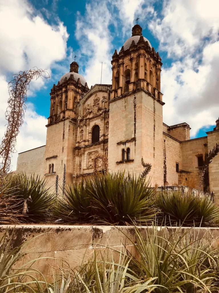 brown concrete building under blue sky and white clouds during daytime Oaxaca itinerary