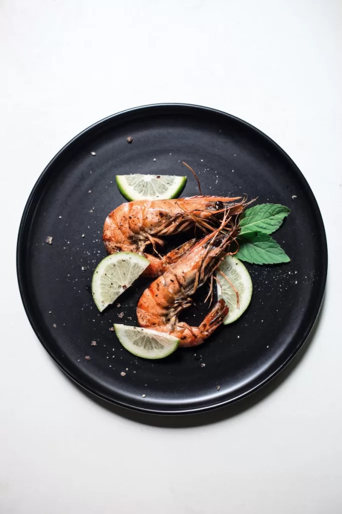 cooked shrimp with sliced of lime and basil in Ensenada