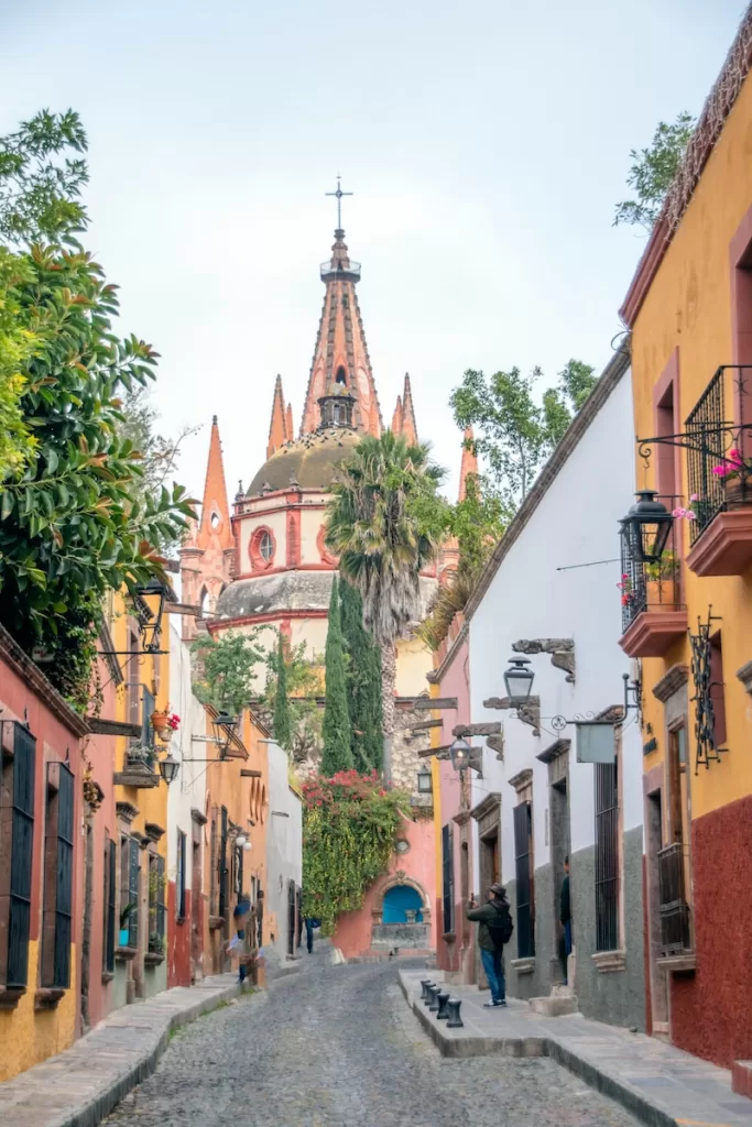 people walking on street near buildings during daytime. San Miguel de Allende city safest cities in mexico