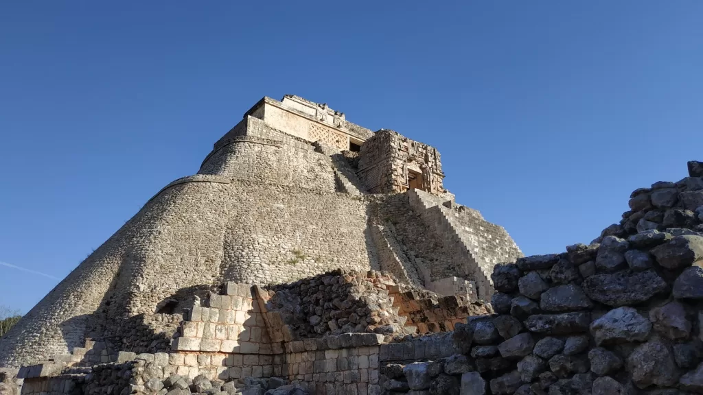 gray concrete building under blue sky during  Uxmal ruins daytime