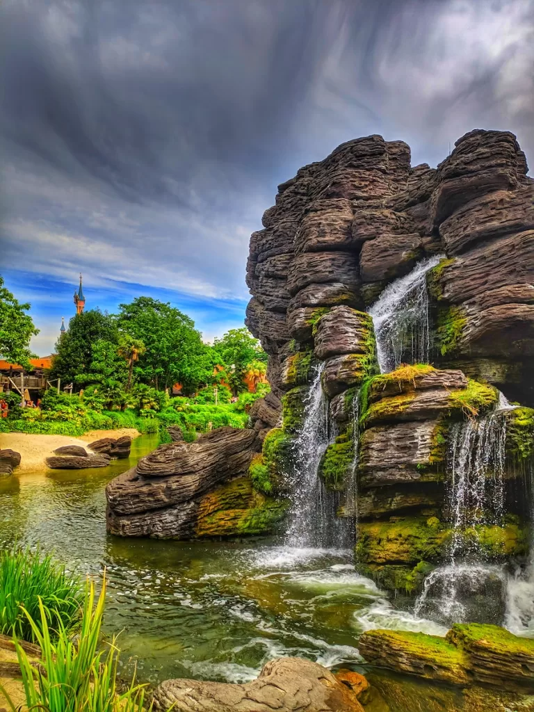 a waterfall in the middle of a lush green park waterfall quotes