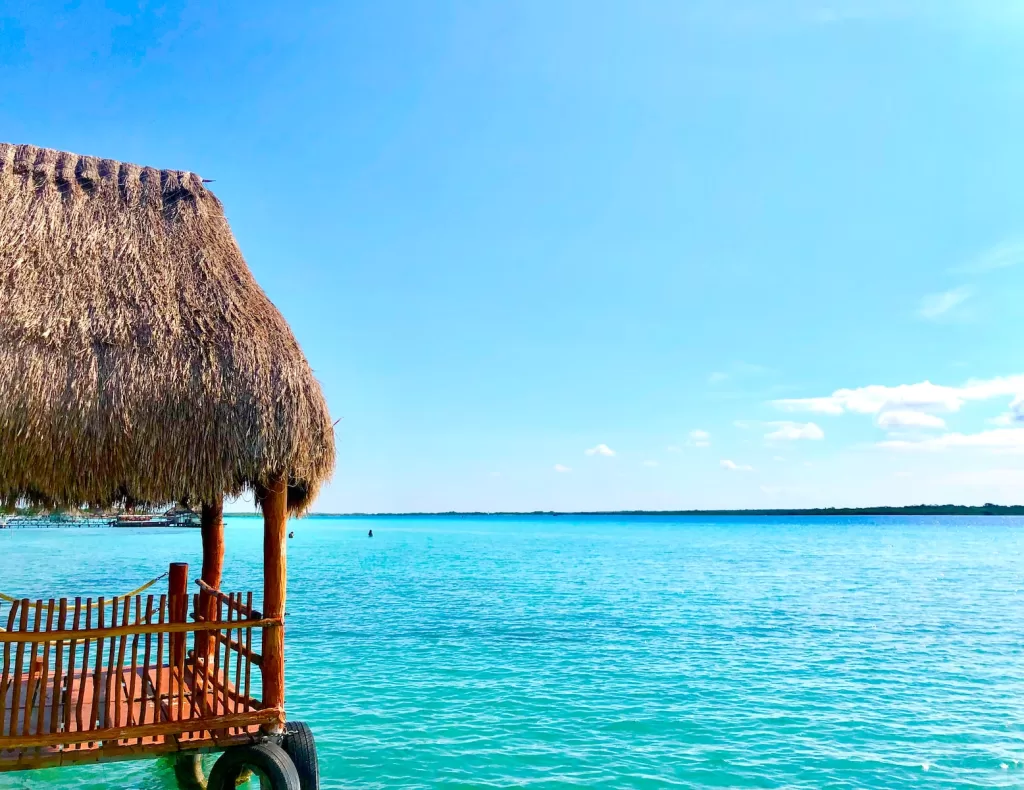 thatch hut above the sea during day bacalar mexico
