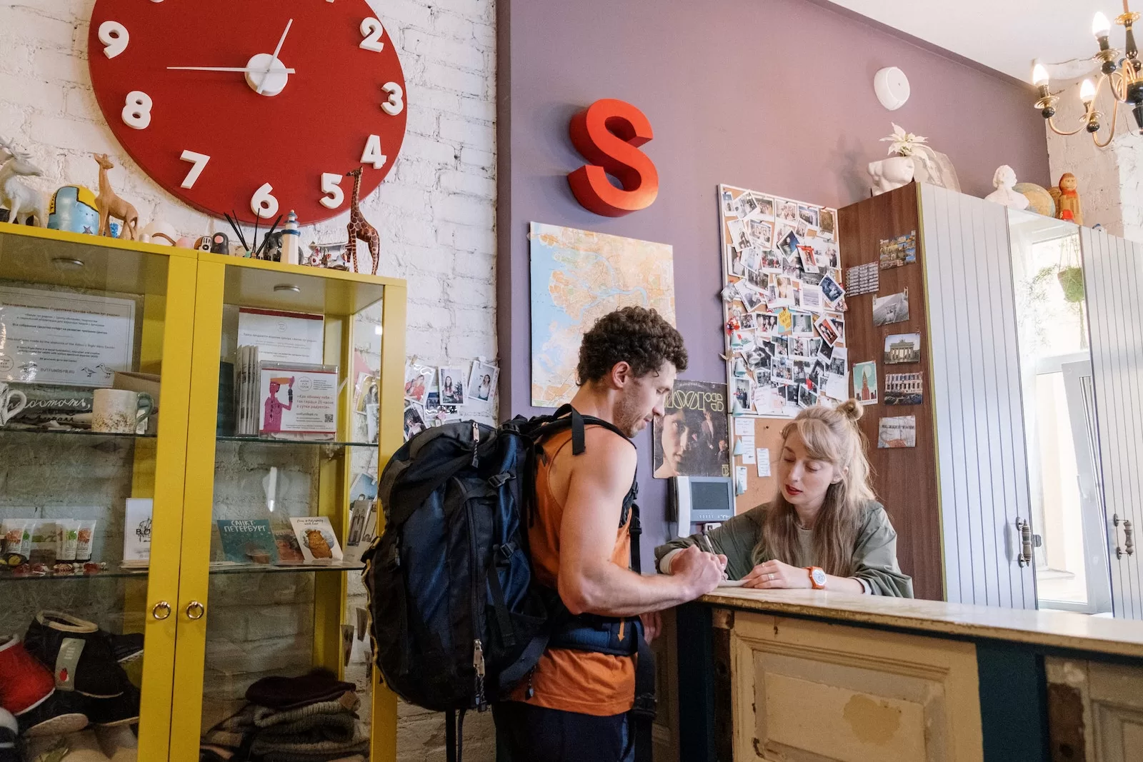 Tourist Standing in front of Reception Desk hostels in europe