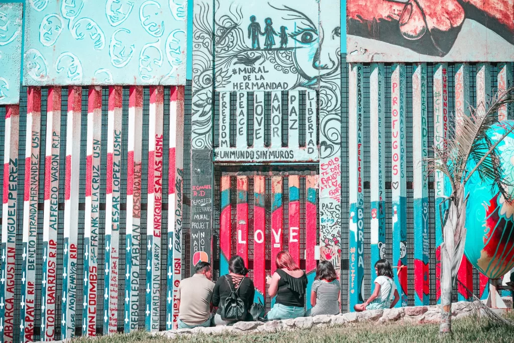 a group of people sitting on a bench in front of a building