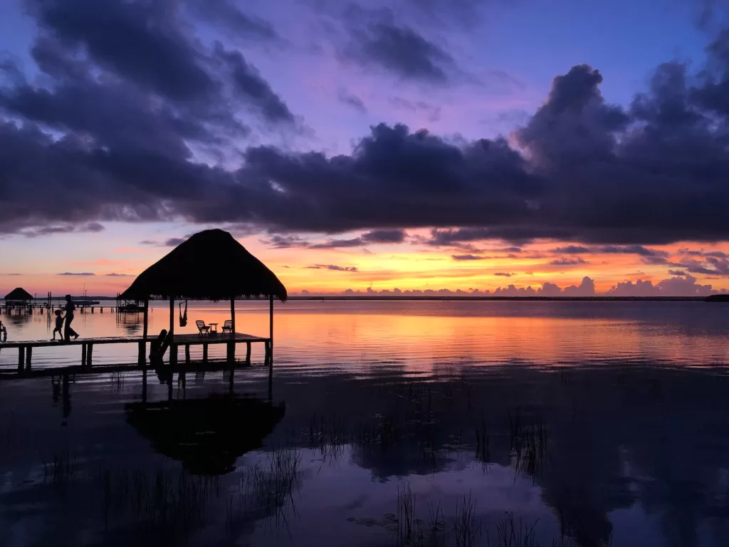 silhouette of gazebo on water during sunset bacalar