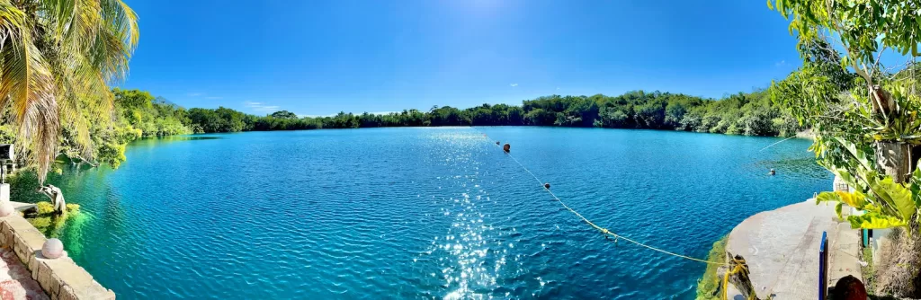 person riding on boat on sea during daytime bacalar