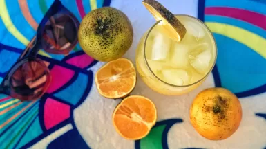 sliced lemon beside clear drinking glass mezcal vs tequila