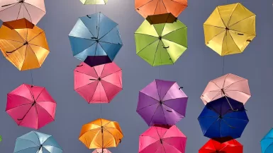 a bunch of colorful umbrellas hanging in the air in Tlaquepaque Jalisco