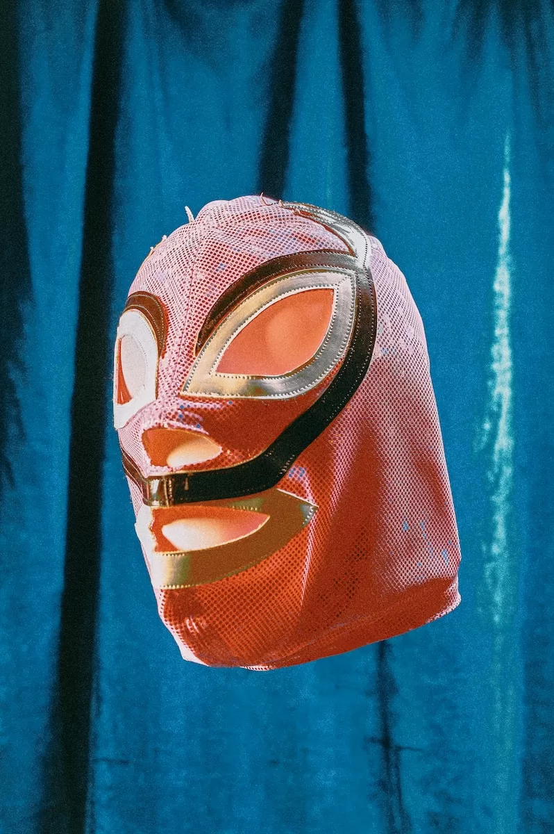 orange and black mask on blue textile Lucha Libre in Mexico City