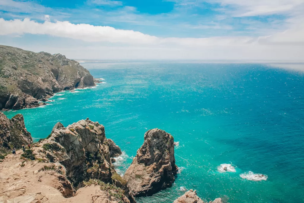 brown rock formation on blue sea under blue sky during daytime and safe in cabo