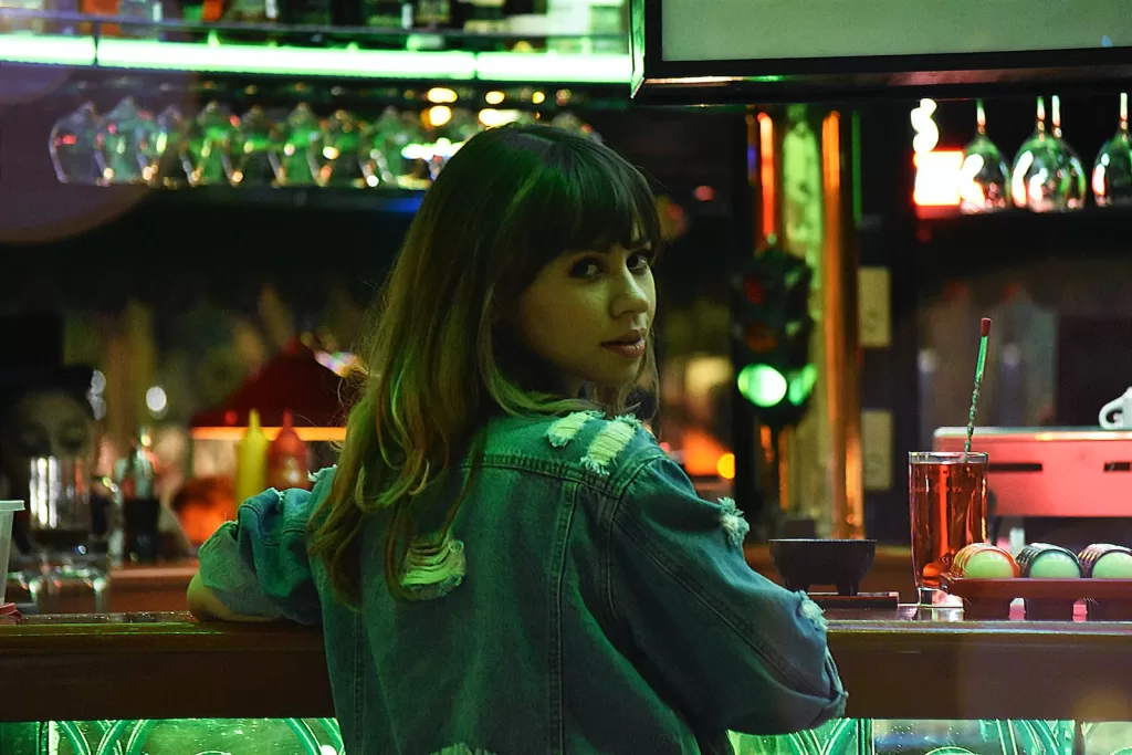 woman in green hoodie standing near counter of a Bars in Guadalajara