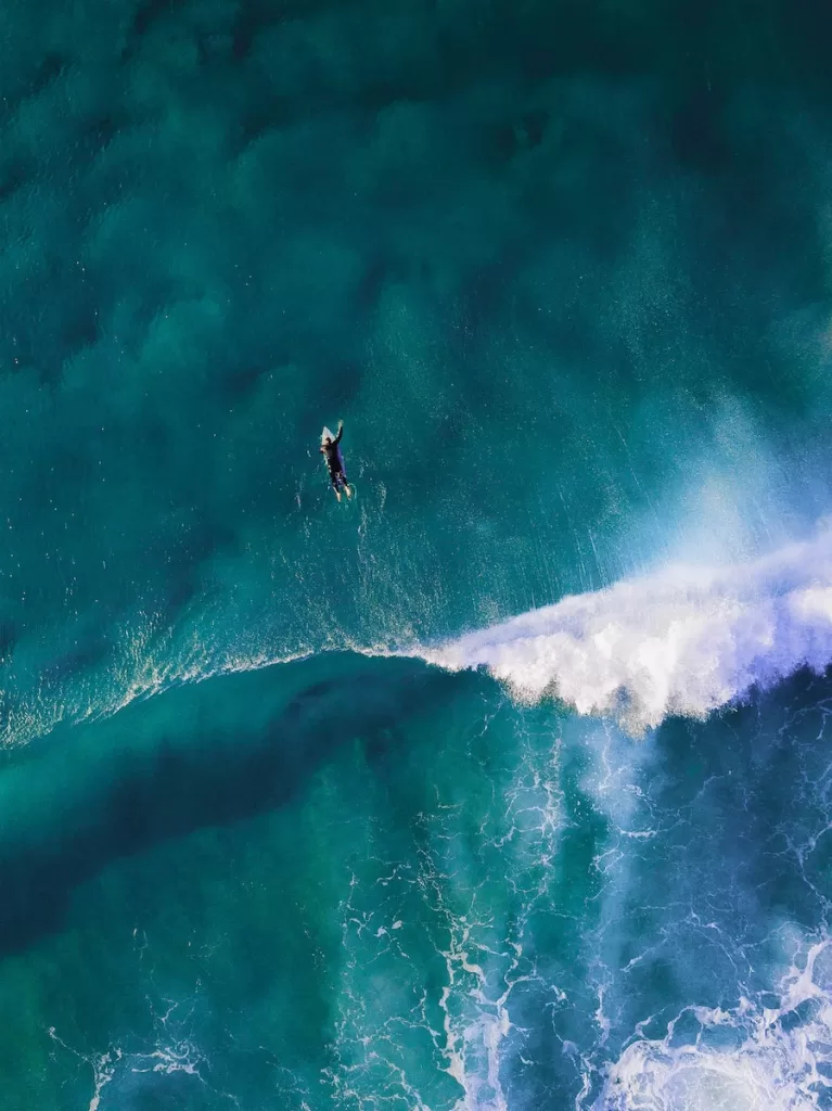 high-angle photography of man surfing giant wave Todos Santos, Baja California Sur