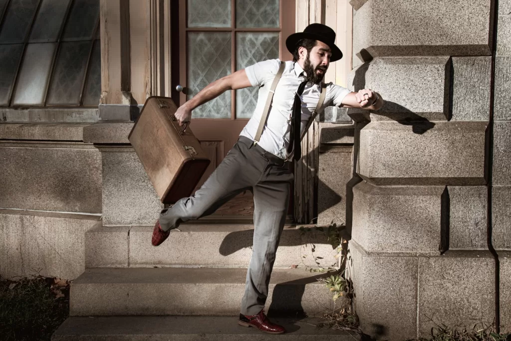 man in white dress shirt and gray pants sitting on gray concrete stairs "Ahorita" mexico travel tips