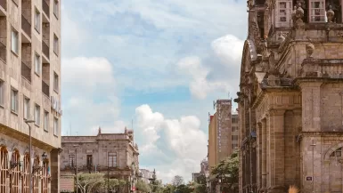 people walking near brown ancient cathedral under white and cloudy skies, but is guadalajara safe?