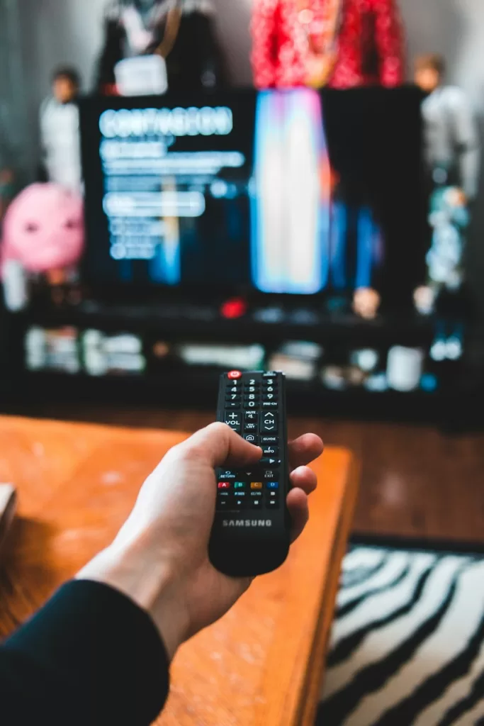 person holding black remote control on mushrooms