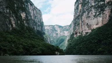 a body of water surrounded by mountains and trees in Sumidero Canyon