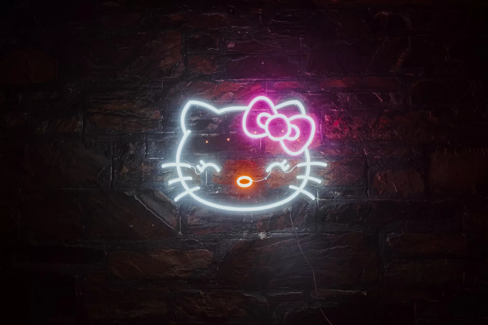 a neon hello kitty sign on a brick wall and Hello Kitty Travel Case