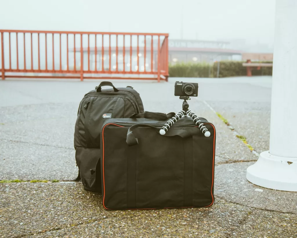 camera mounted on tripod on top of luggage bag Best Tripod for Travel Enthusiasts