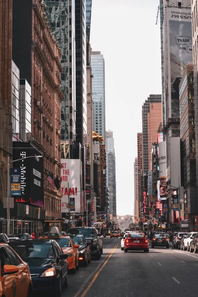 vehicles on road between concrete buildings in New York, United States