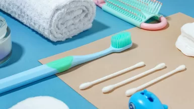 a blue toothbrush, toothpaste, toothpaste, and other items and Best Travel Toothbrushes