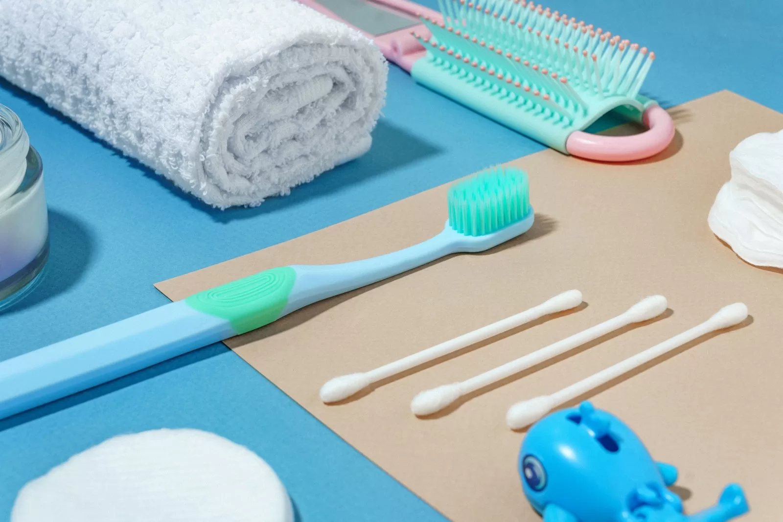 a blue toothbrush, toothpaste, toothpaste, and other items and Best Travel Toothbrushes