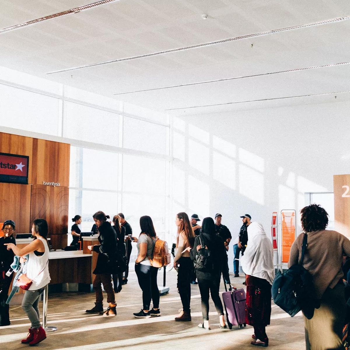 a group of people standing in a large room in the Guadalajara Airport