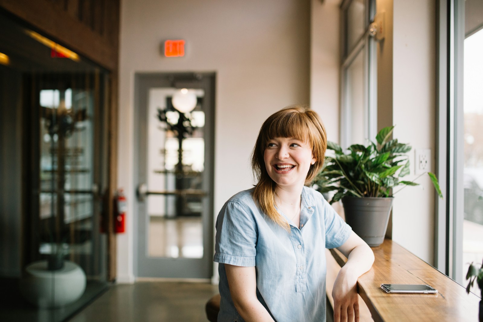 woman sitting in front of brown wooden table of a travel CNA job