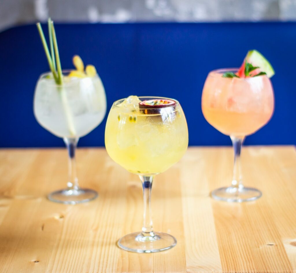 three clear drinking glass on table tropical punch