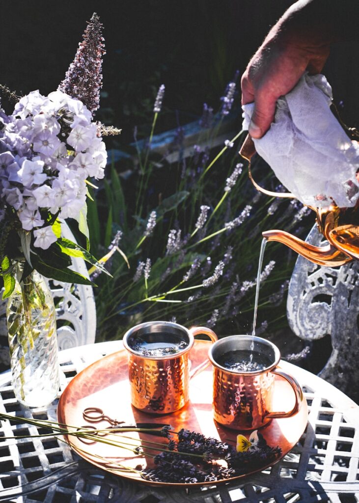 a person pouring liquid into a glass Lavender Lemon