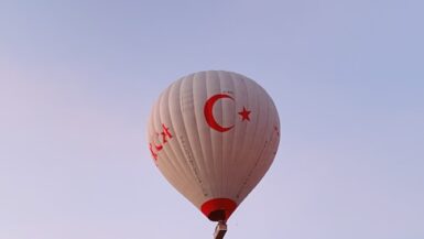 a hot air balloon flying over a rocky landscape Bucket List