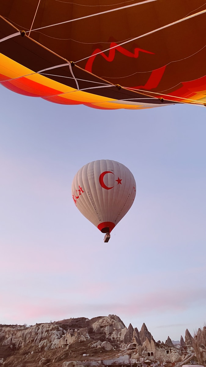 a hot air balloon flying over a rocky landscape Bucket List