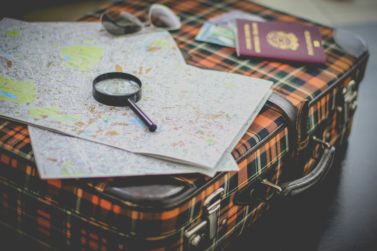 black magnifying glass on map Travel Plans