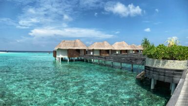 brown wooden house on body of water under blue sky during daytime Travel Bucket List