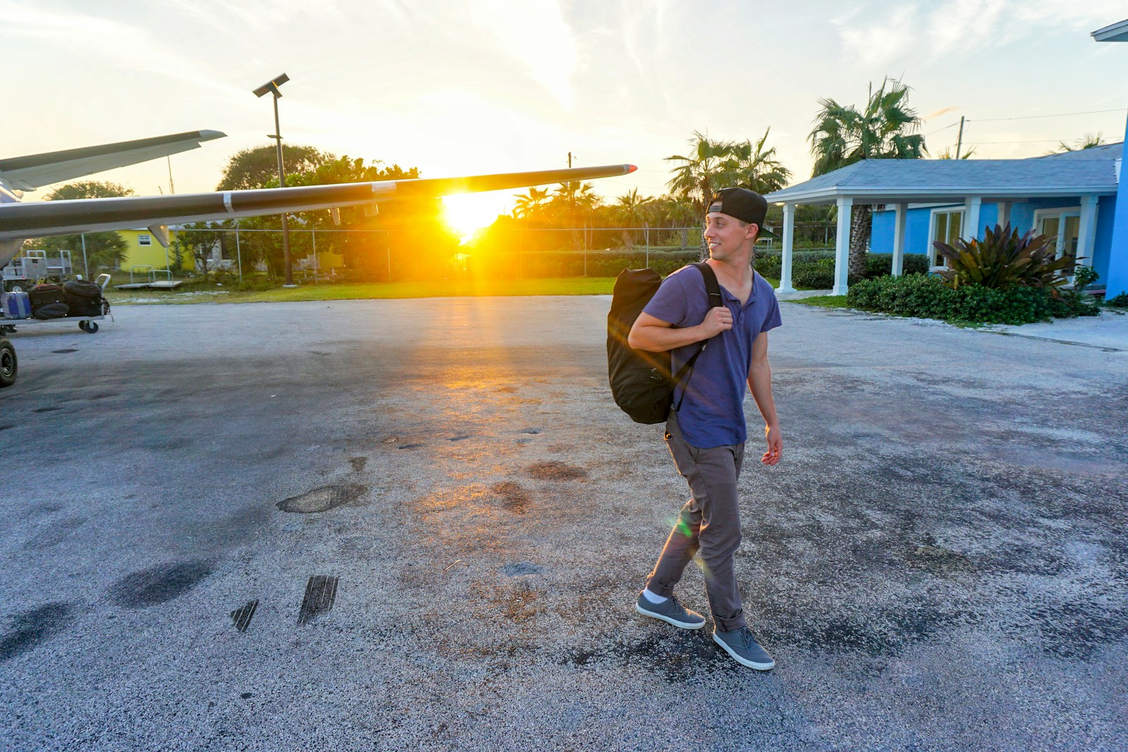 smiling man walking while looking side view Travel Hacks