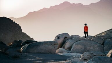 a person standing on top of a large rock