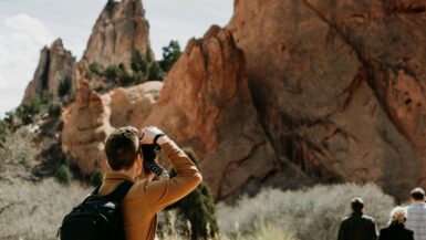 man taking photo of rock formation Outdoor Adventures