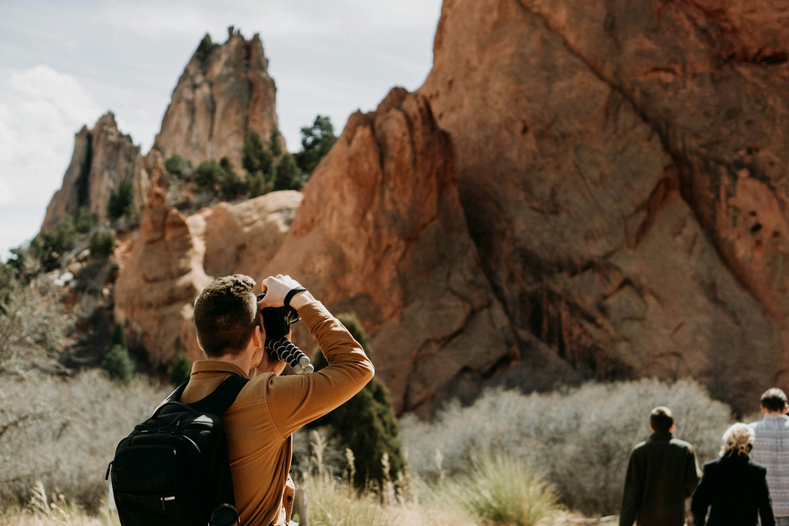 man taking photo of rock formation Outdoor Adventures