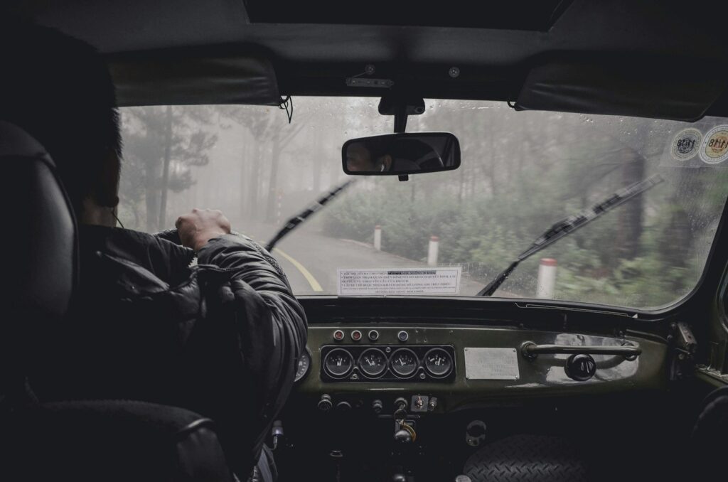 man driving car during rainy daytime private driver