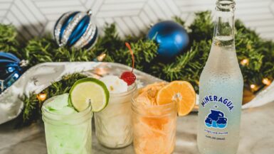 a bottle of lemonade next to three glasses of lemonade mocktail bar atlanta