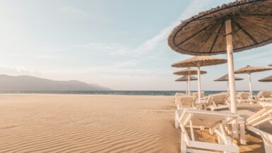 lounge chairs with umbrellas at the beach Weekend Getaway during day