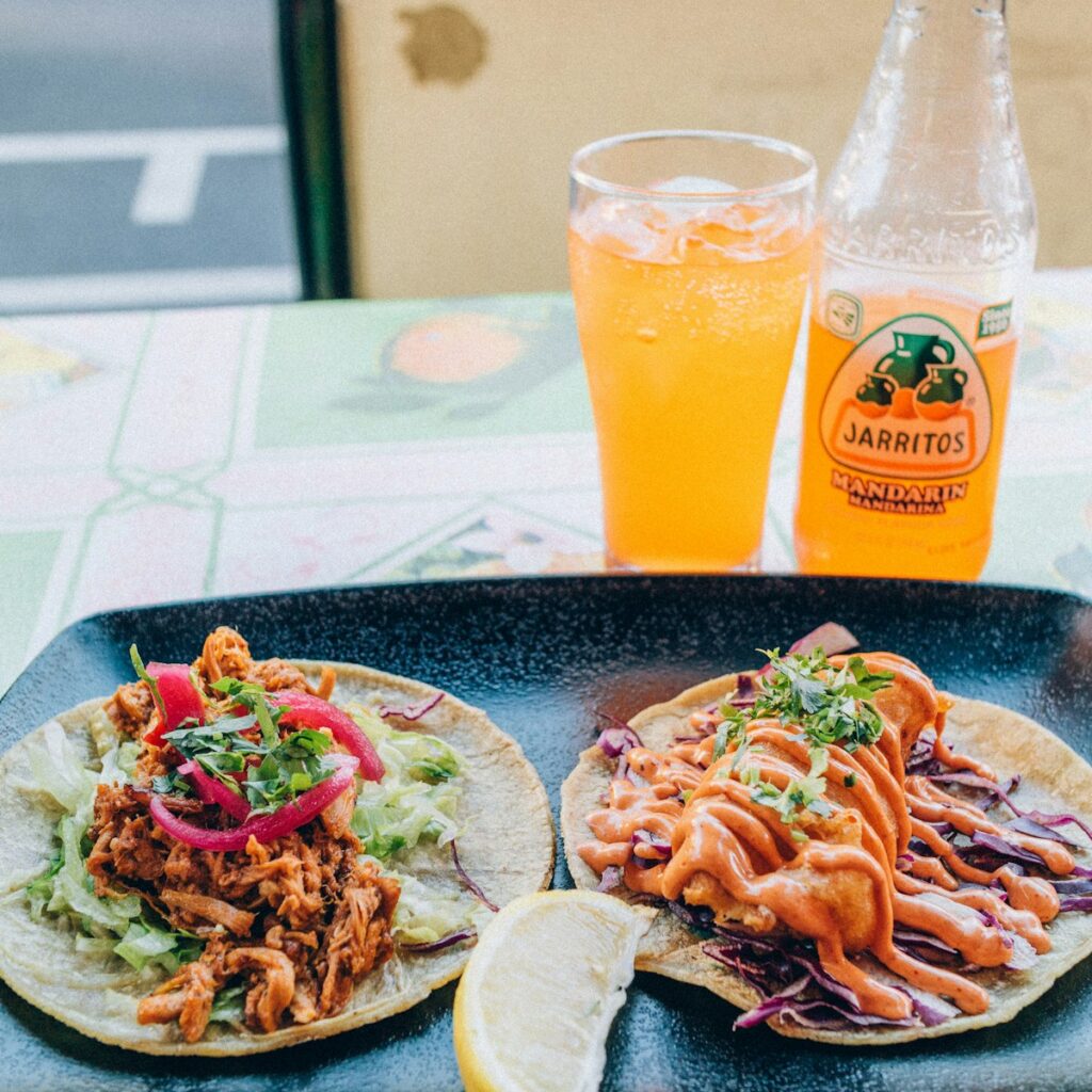 a couple of tacos sitting on top of a plate south coastline of of ensenada mexico