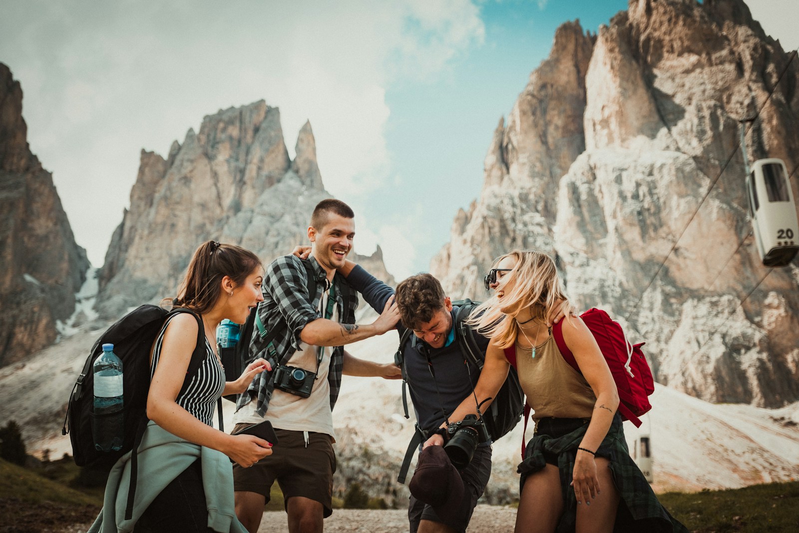 low-angle photography of two men playing beside two women travel friends