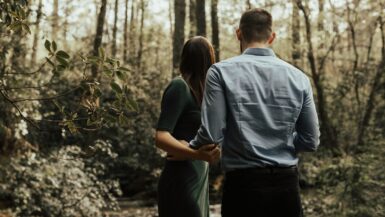 man and woman standing inside forest Outdoor Lovers