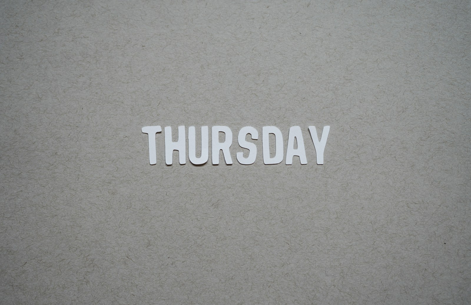 the word thursday cut out of paper